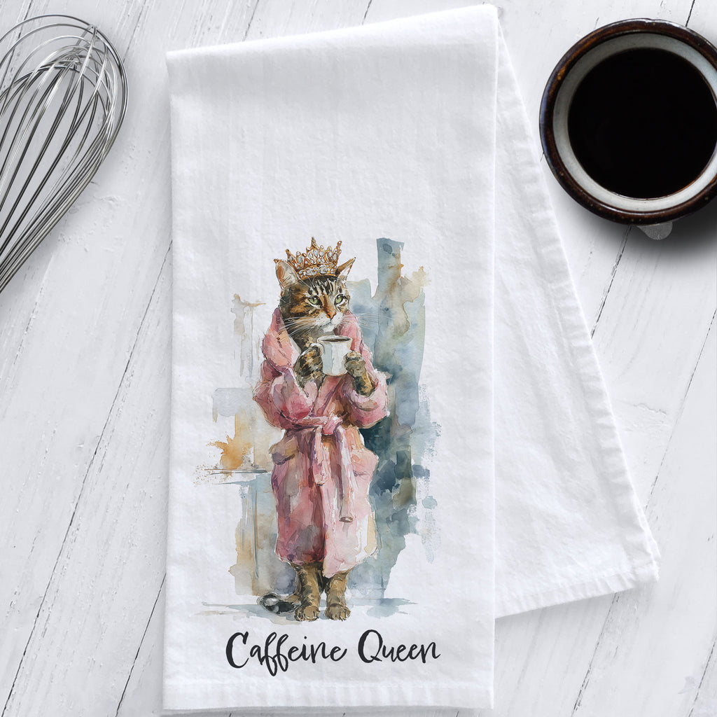 Flour sack tea towel with watercolor art of a cat wearing a crown and pink robe holding coffee, labeled “Caffeine Queen.”