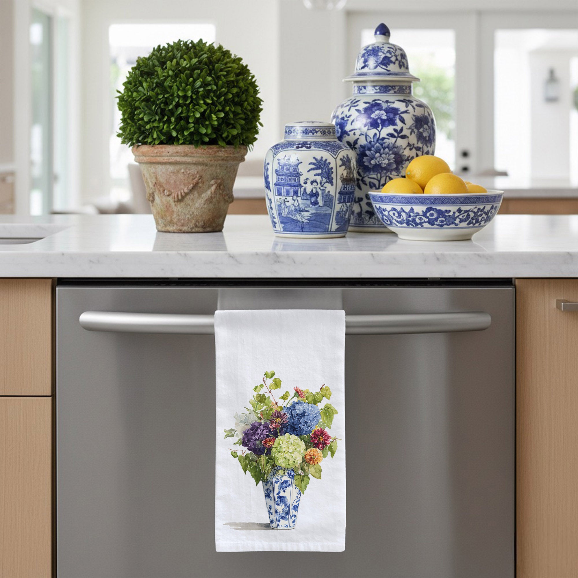 White flour sack tea towel with a blue and white chinoiserie vase with hydrangea and zinnia flowers