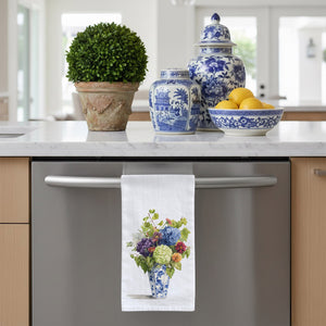 White flour sack tea towel with a blue and white chinoiserie vase with hydrangea and zinnia flowers