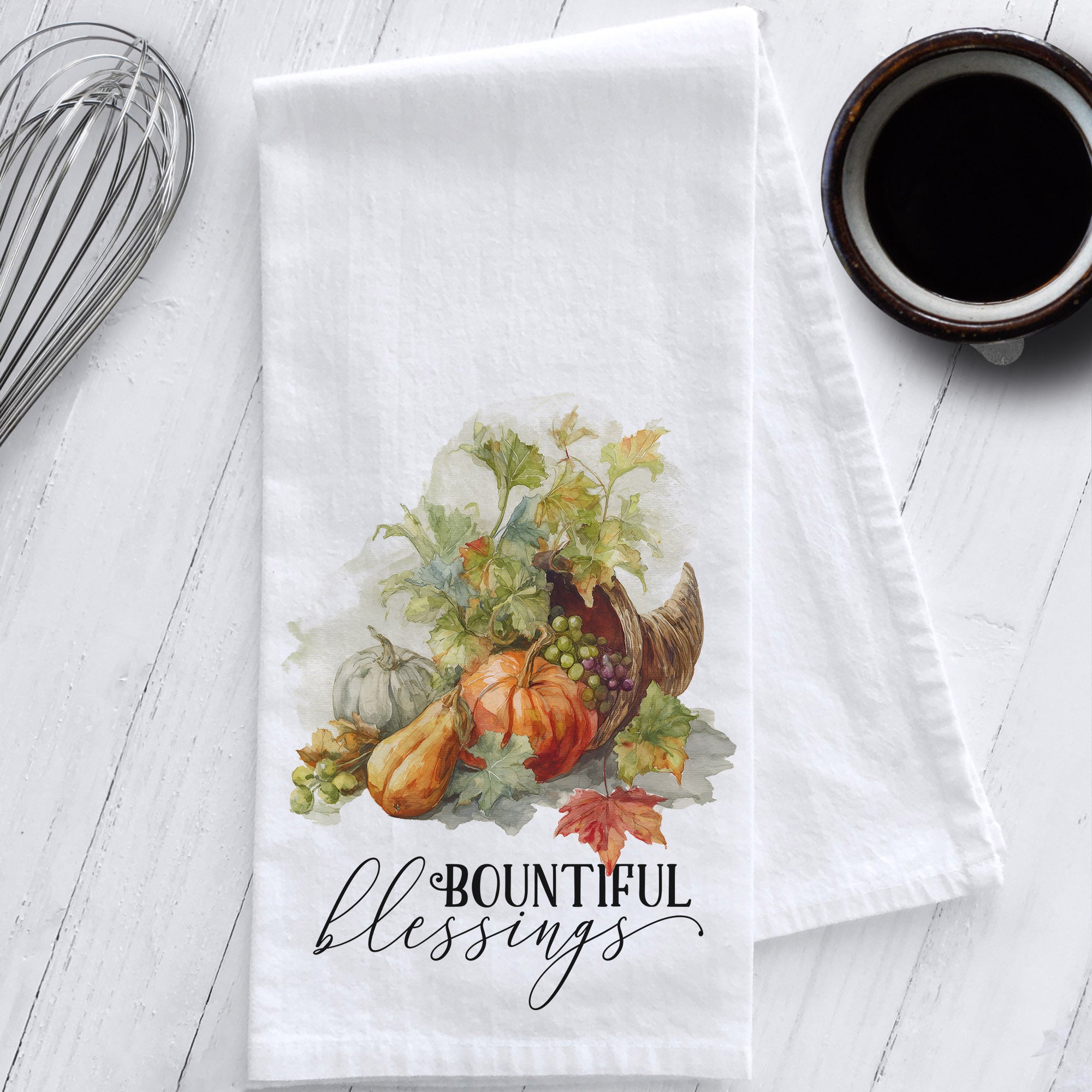Flour sack tea towel with watercolor cornucopia art, featuring pumpkins, gourds, fall leaves, and the phrase "Bountiful Blessings."