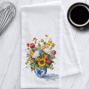 White flour sack tea towel featuring vibrant fall watercolor flowers in a blue and white chinoiserie vase; styled on white kitchen counter.